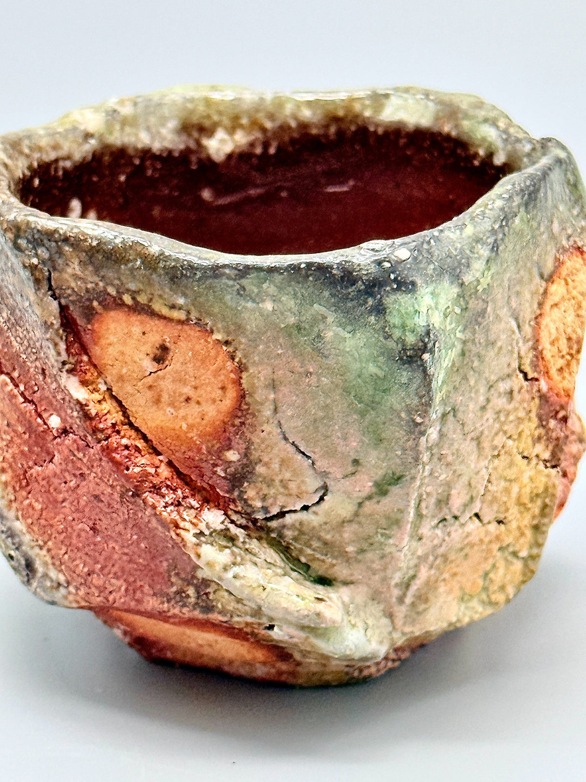 Detail of green glaze, orange clay and pale inclusions on Atarashi Manabu Iga kurinuki cup.