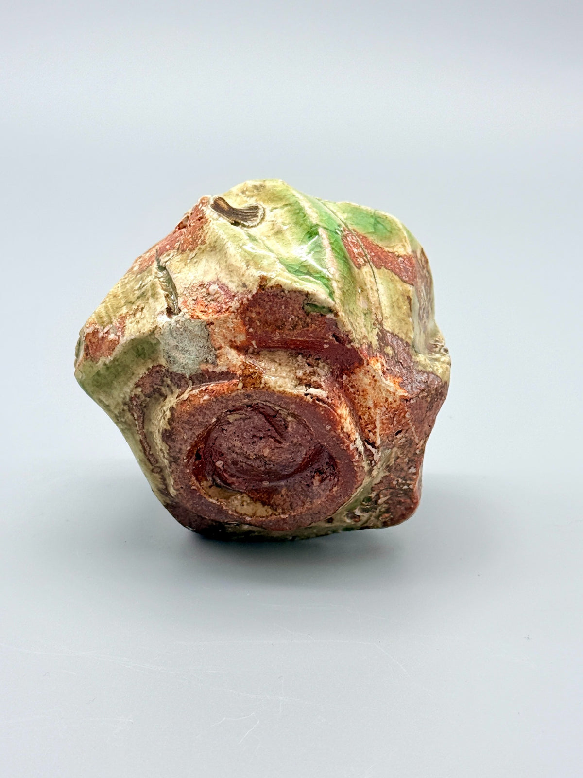 Recessed foot and rugged reddish-brown clay beneath Atarashi Manabu Iga cup.