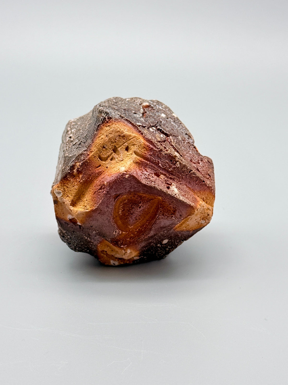 Recessed foot and exposed orange-ochre clay beneath Atarashi Manabu hikidashi black Iga cup.