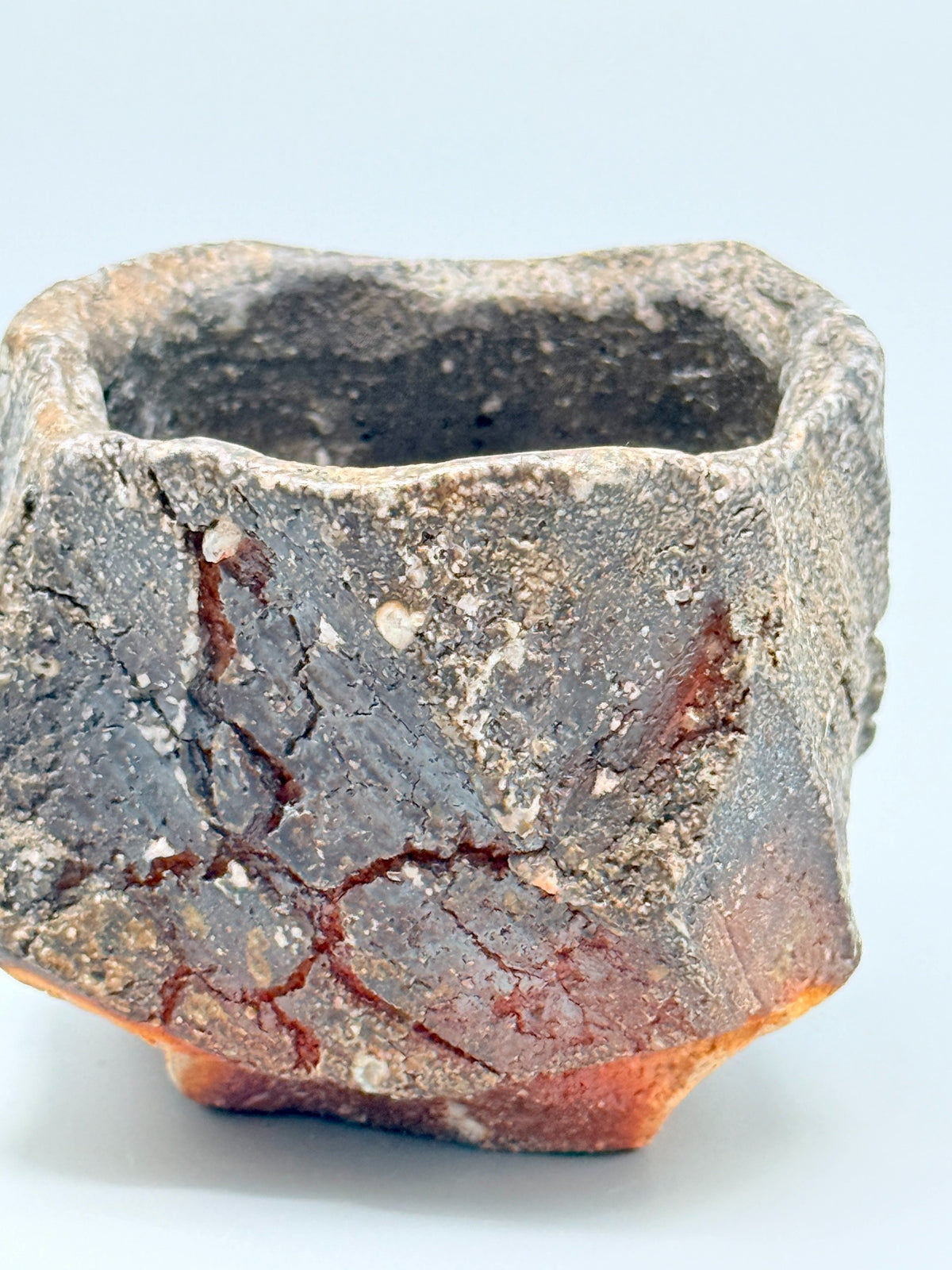 Detail of white mineral inclusions, iron-grey texture and reddish-brown surface lines on Atarashi Manabu Iga cup.