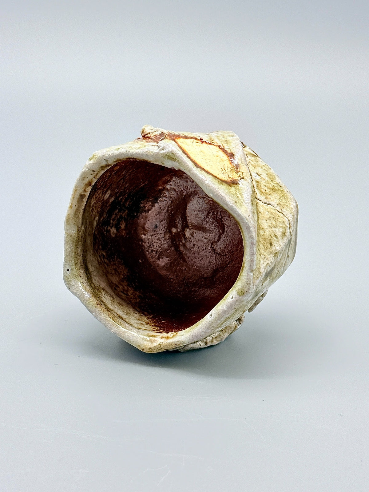 Warm brown interior and pale glazed rim of Atarashi Manabu Iga kurinuki cup.