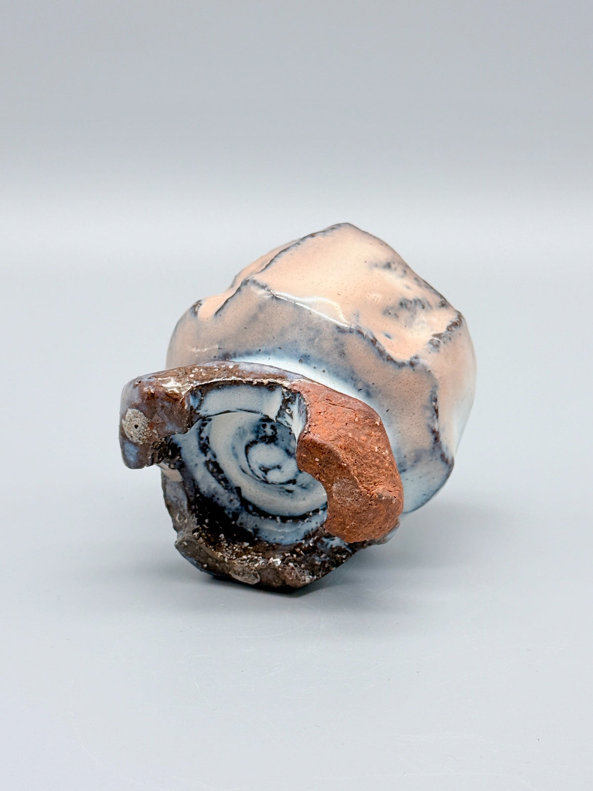 Underside of Kaneta Masanao footed cup, showing the recessed base, glaze and exposed clay.